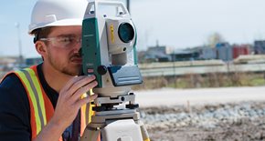 Guy using surveying equipment